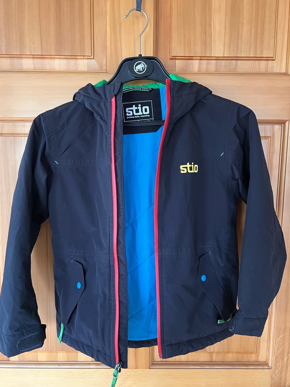 Stio Kids Black Hooded Raincoat with Blue Lining and Red Trim